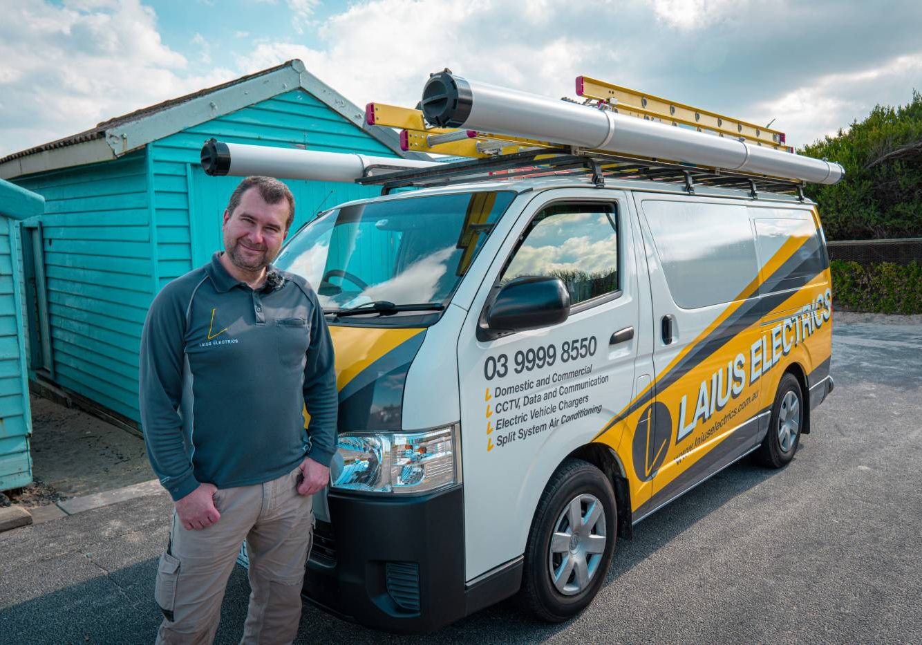 Electrician beside the Laius Electrics van