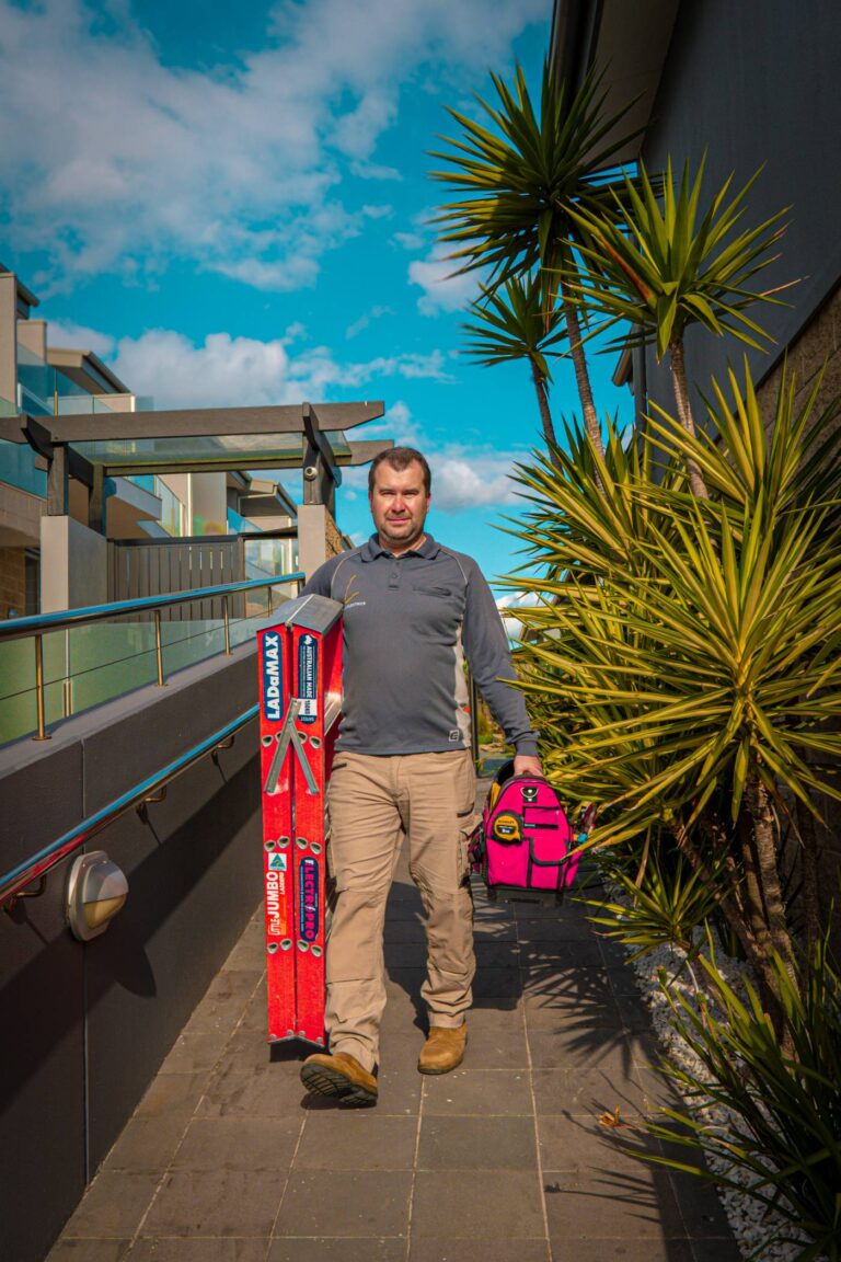 Laius Electrics electrician carrying ladder and tool bag